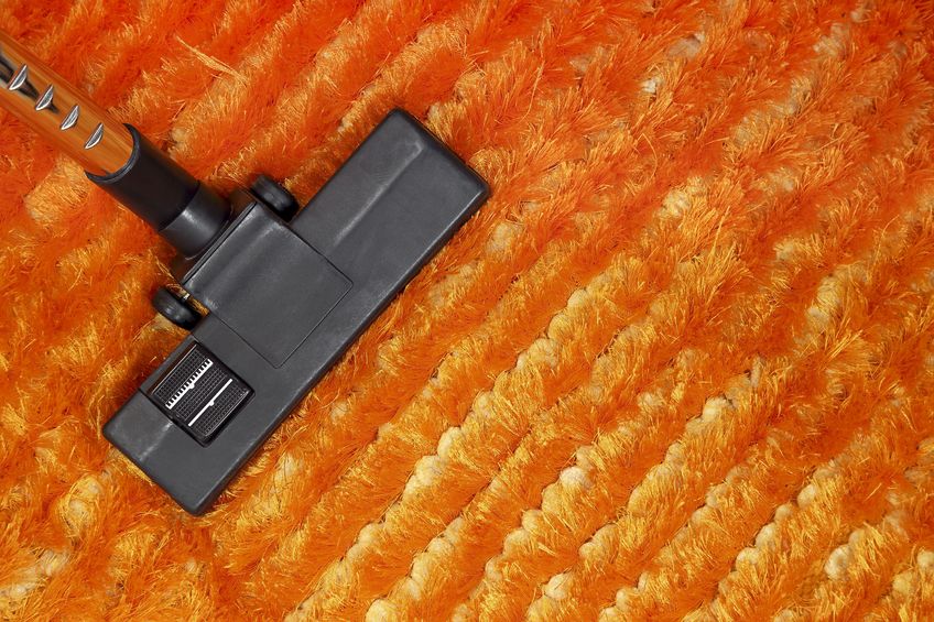 19638656 - vacuum cleaner on orange carpet